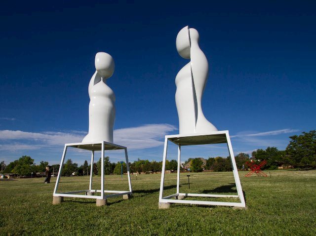 Two white sculptures shaped like abstract figures in our sculpture field